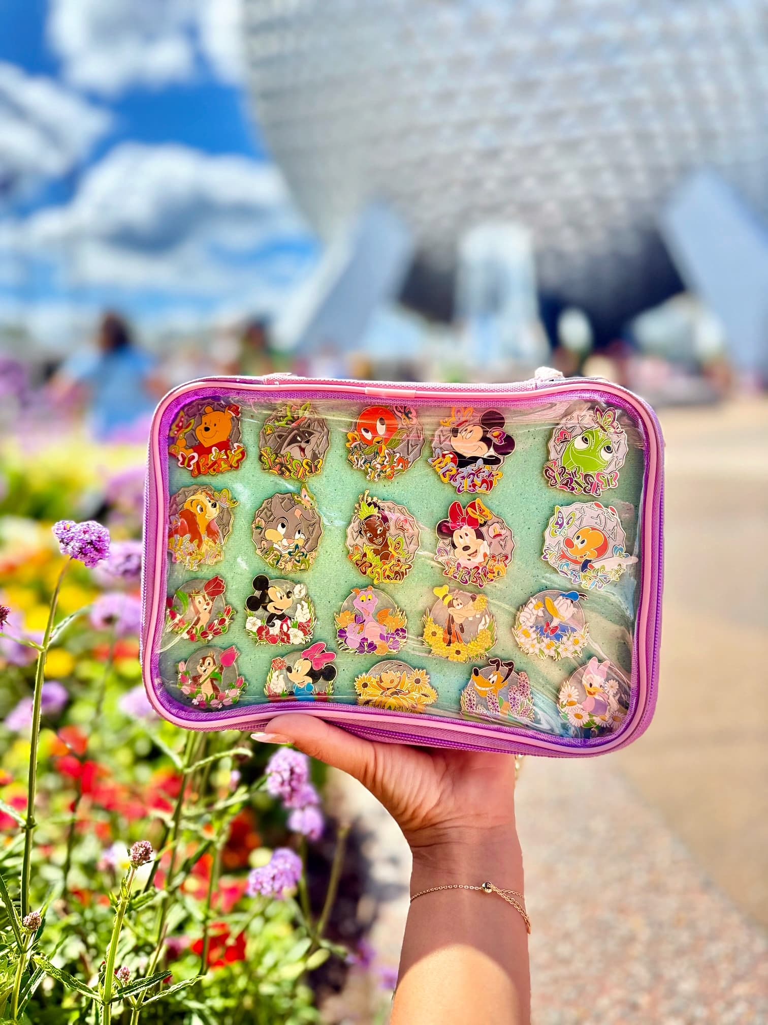 A pin trading pouch held up on a sunny day