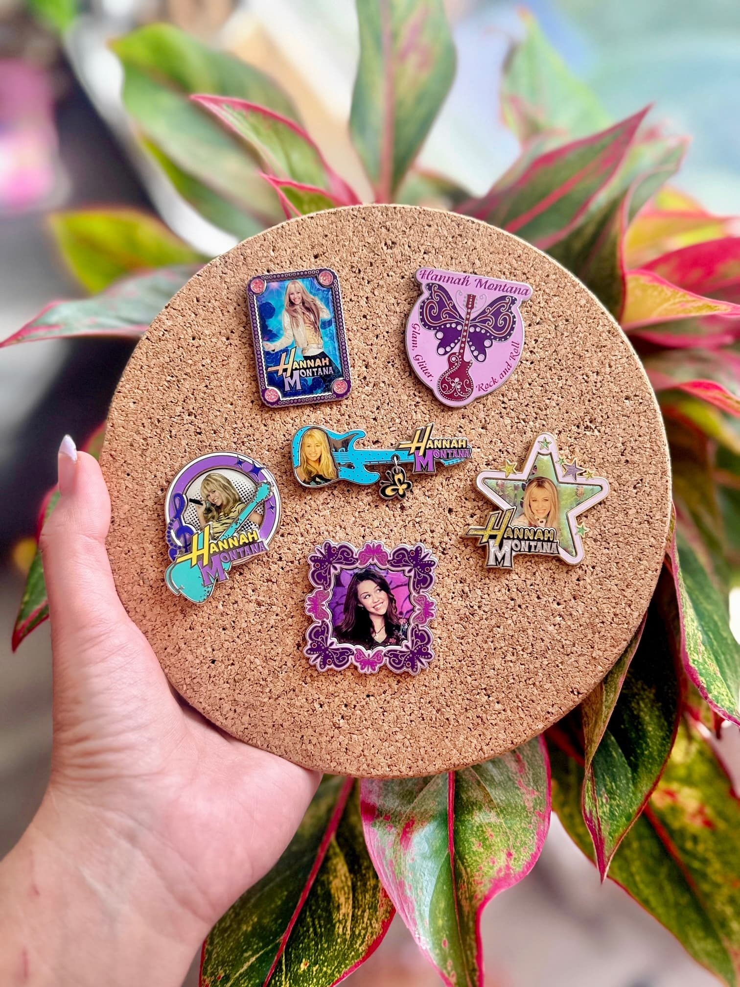 Vintage character pins arranged on a cork board