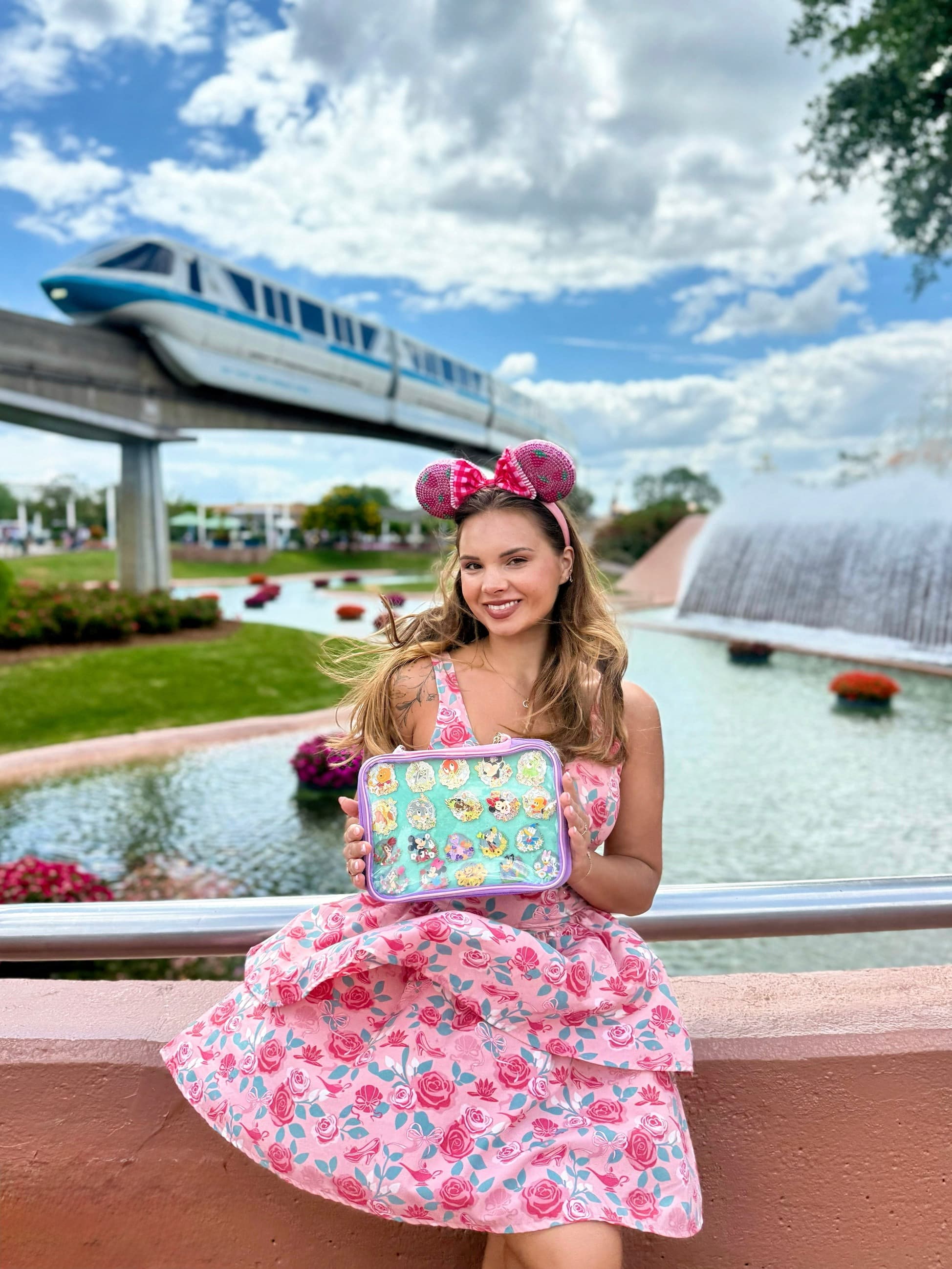 Veronika holding a case of enamel pins